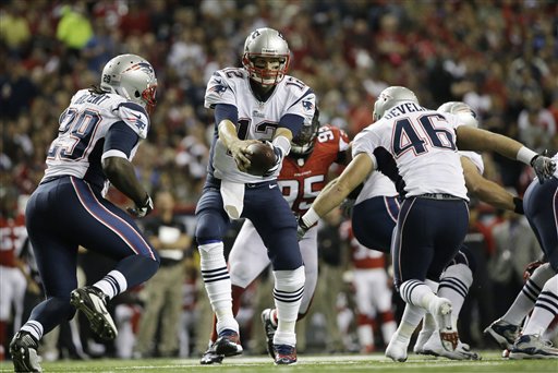 New England Patriots quarterback Tom Brady (12) works against the Atlanta Falcons during the first half of Sunday's game in Atlanta. Georgia Dome