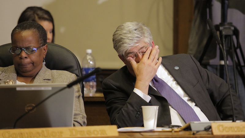 City Councilman Nicholas Mavodones, at right, rubs his eyes during a city council meeting Monday, September 9, 2013, that went longer than three hours as citizens packed the city council chamber to speak on the proposed sale of Congress Square. At left is City Councilwoman Jill Duson.