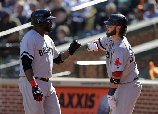 David Ortiz, left, fist-bumps teammate Jarrod Saltalamacchia after scoring a run on a sacrifice ground ball by Mike Carp in the first inning of Sunday's game against the Orioles in Baltimore.