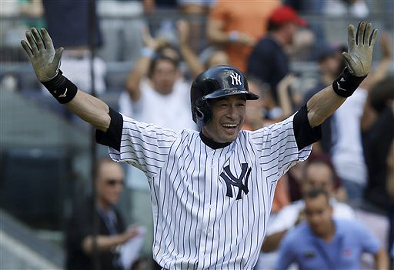 New York’s Ichiro Suzuki reacts with glee after scoring the winning run on a wild pitch in the ninth inning at Yankee Stadium on Sunday afternoon.