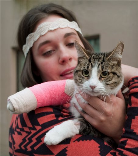 Stephanie Gustafson holds her 2-year-old female cat, Wasabi, after returning from a veterinarian hospital in Juneau, Alaska.
