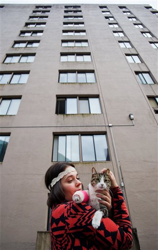Stephanie Gustafson holds Wasabi in front of the Mendenhall Apartment building in Juneau, Alaska.