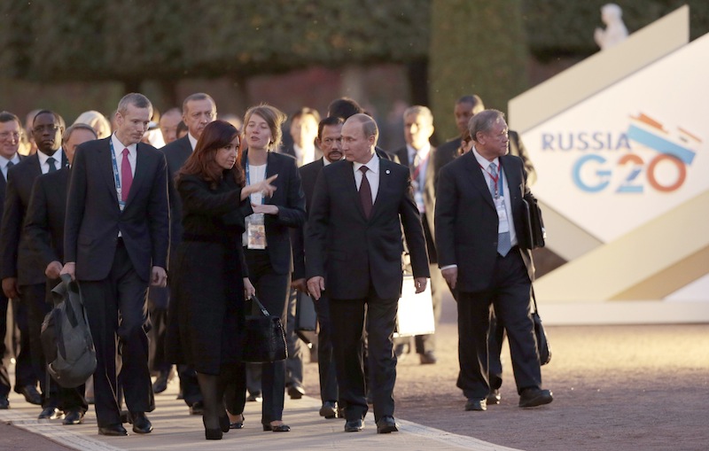 Russia's President Vladimir Putin, front center right, speaks with Argentina's President Cristina Fernandez de Kirchner, front center left, as they walk with other G-20 leaders toward a dinner at the Peterhof Palace in St. Petersburg, Russia on Thursday, Sept. 5, 2013. The threat of missiles over the Mediterranean is weighing on world leaders meeting on the shores of the Baltic this week, and eclipsing economic battles that usually dominate when the G-20 world economies meet. (AP Photo/Ivan Sekretarev) G20;G-20;Group of 20