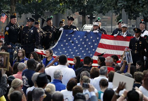 The World Trade Center Flag is presented as friends and relatives of the victims of the 9/11 terrorist attacks gather at the National September 11 Memorial at the World Trade Center site on Wednesday.