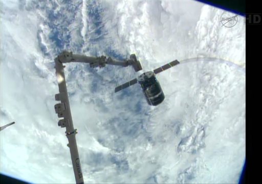 This framegrabbed image provided by NASA-TV shows the Cygnus spacecraft as it approaches the International Space Station Sunday. The Canadarm 2 which will grapple the spacecraft can be seen lower left.