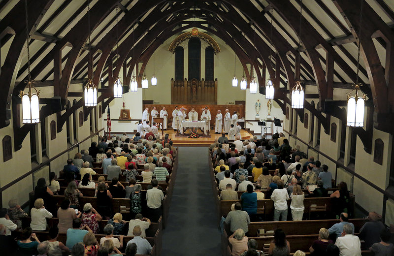 Parishioners at St. John the Evangelist Catholic Church in South Portland celebrated their last Mass Wednesday night. The church will merge with Holy Cross, also in South Portland, and the building will be sold.