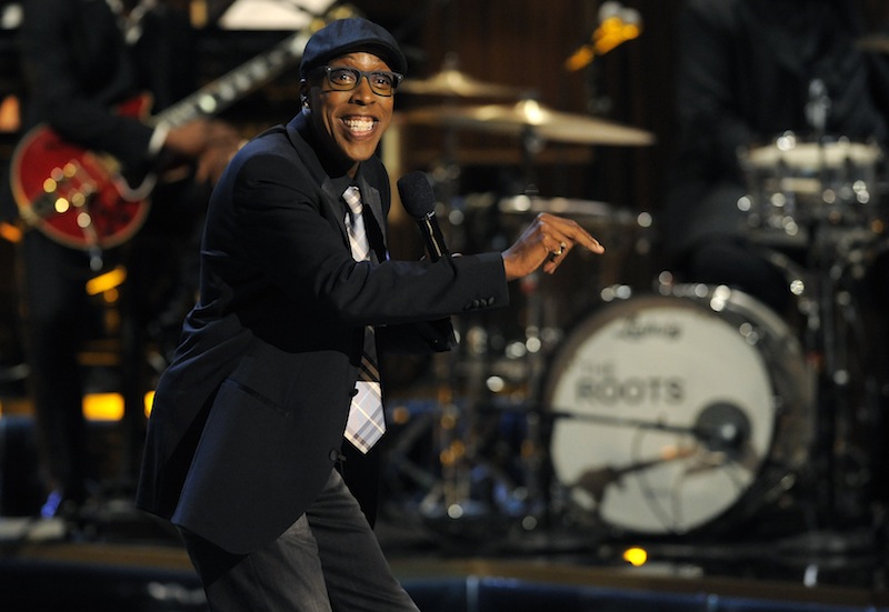 This Nov. 3, 2012 file photo shows Arsenio Hall performing at "Eddie Murphy: One Night Only," a celebration of Murphy's career in Beverly Hills, Calif. After two decades, Hall is returning to late night television with "The Arsenio Hall Show," premiering on Sept. 9. (Photo by Chris Pizzello/Invision/AP, File) Black Blazer,Black Hat,Black Jacket,Eyewear,Glasses,Live Performance,Long Sleeve,Long Sleeves,On Stage,One Person,Perform,Performance,Performing,Smile,Smiling,Speak,Speaking,Spectacles,Talk,Talking