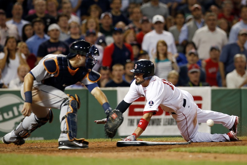 Boston Red Sox's Shane Victorino slides into home plate, beating the throw into Detroit Tigers catcher Alex Avila, to score by tagging up on a fly ball by Dustin Pedroia in the fifth inning of a baseball game at Fenway Park in Boston, Wednesday, Sept. 4, 2013. (AP Photo/Elise Amendola)