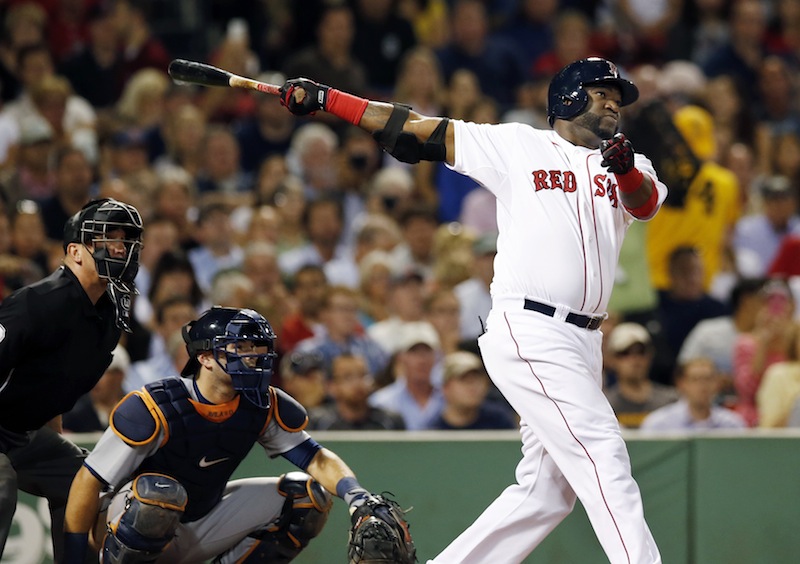 Boston Red Sox designated hitter David Ortiz follows through on a solo home run as Detroit Tigers catcher Alex Avila watches during the fourth inning of a baseball game at Fenway Park in Boston, Wednesday, Sept. 4, 2013. (AP Photo/Elise Amendola)