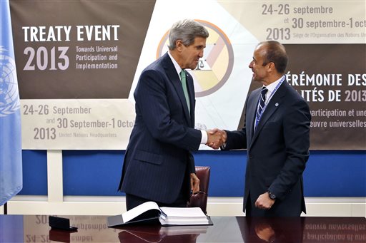 U.S. Secretary of State John Kerry, left, shakes hands with Under Secretary-General for Legal Affairs Miguel Serpa Soares after signing the Arms Trade Treaty during the 68th session of the United Nations General Assembly at U.N. headquarters, Wednesday, Sept. 25. (AP Photo/Jason DeCrow)