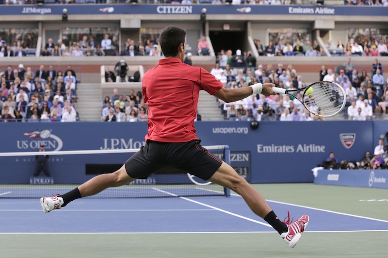 Novak Djokovic, of Serbia, returns a shot to Rafael Nadal, of Spain, during the men's singles final of the 2013 U.S. Open tennis tournament, Monday, Sept. 9, 2013, in New York. (AP Photo/Charles Krupa)