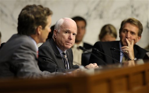 Senate Foreign Relations Committee members Sen. John McCain, R-Ariz, center, and Sen. Rand Paul, R-Ky., left, talk on Capitol Hill Wednesday during the committee's hearing to consider the authorization for use of military force in Syria. Sen. Jeff Flake, R-Ariz. is at right.