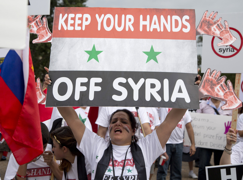 Protesters against U.S. military action in Syria shout during a demonstration in front of the White House in Washington on Monday. On Tuesday, President Barack Obama will address the nation regarding Syria.