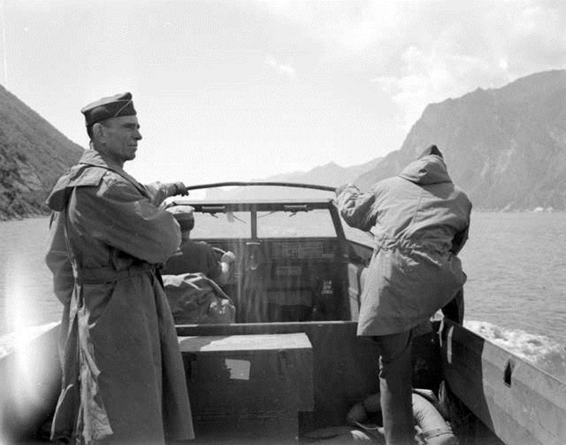 In this historic image, Gen.George P. Hays, left, leads an American amphibious vehicle as it crosses an Italian lake during World War II.