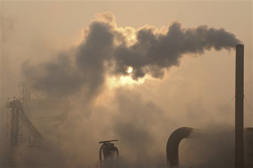 Smoke pours from a chimney at a cement plant in Binzhou city, in eastern China's Shandong province. Scientists from around the world have gathered in Stockholm for a meeting of a U.N. panel on climate change and will probably issue a report saying it is "extremely likely" that humans are mostly to blame for temperatures that have climbed since 1951.