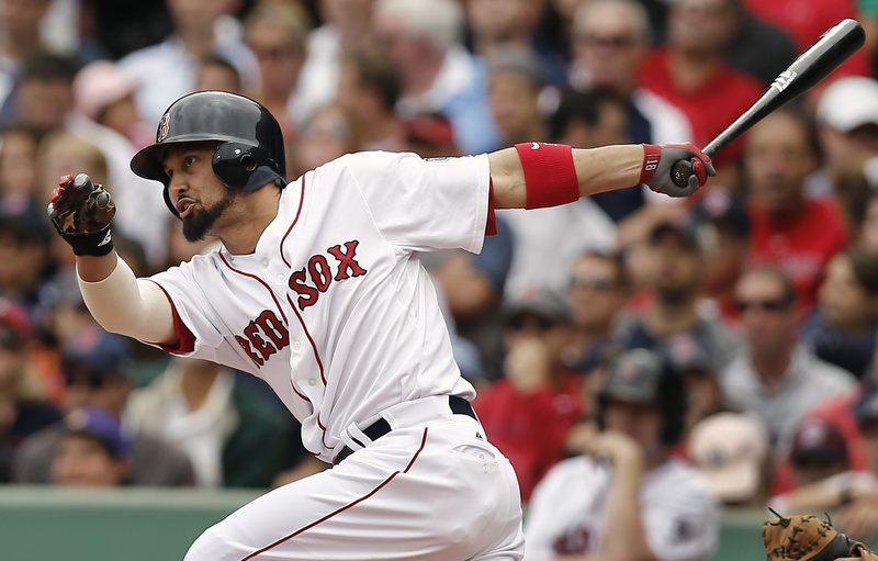 Boston's Shane Victorino follows through with an RBI single against the New York Yankees during the fourth inning at Fenway Park on Saturday.