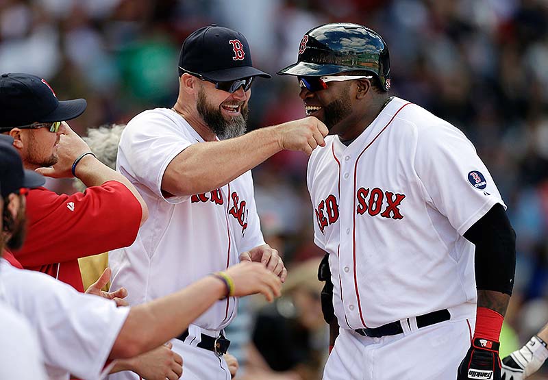 David Ortiz is welcomed to the dugout by David Ross after hitting a sixth-inning home run Sunday at Fenway Park.