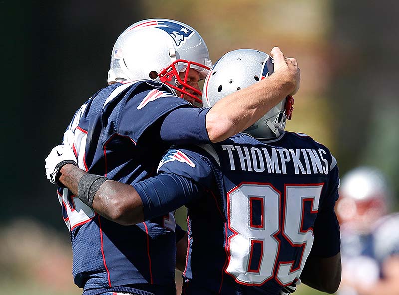 Patriots QB Tom Brady, left, celebrates his touchdown pass to wide receiver Kenbrell Thompkins in the first half Sunday at Foxborough, Mass. NFLACTION13;