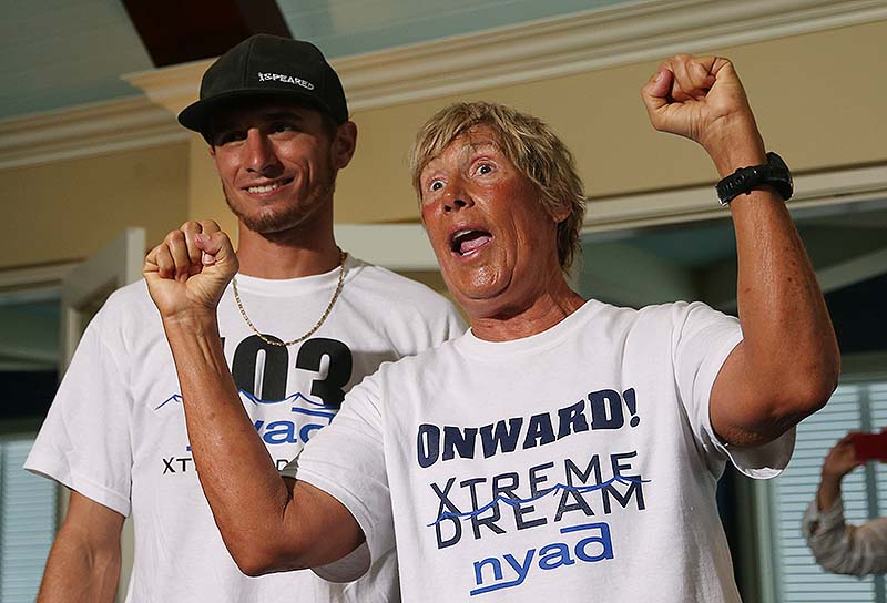 Diana Nyad, right, and one her shark divers, Niko Gazzace, celebrate her record-setting swim from Cuba to Florida, talking to the media during a press conference in Key West, Fla., last Tuesday.