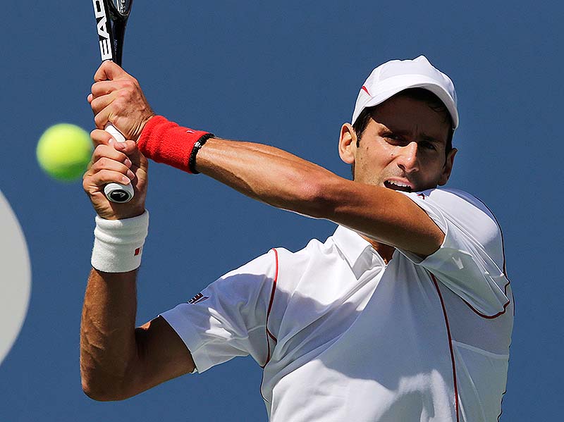 Novak Djokovic returns a shot to Stanislas Wawrinka in the semifinals at the 2013 U.S. Open tennis tournament on Saturday at New York. Djokovic won in five sets.