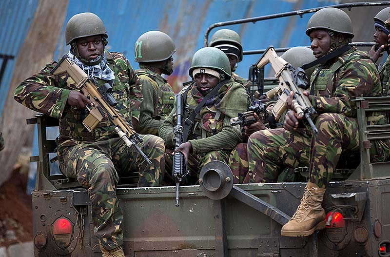 Trucks of soldiers from the Kenya Defense Forces arrive after dawn outside the Westgate Mall in Nairobi, Kenya on Sunday. Islamic extremist gunmen lobbed grenades and fired assault rifles inside Nairobi's top mall Saturday, killing dozens and wounding over a hundred in the attack. Early Sunday morning, 12 hours after the attack began, gunmen remained holed up inside the mall with an unknown number of hostages.