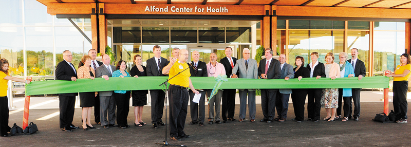 The Rev. David Gant, director of spiritual care, center, says a prayer before a ceremonial ribbon cutting of the MaineGeneral Medical Center’s new Alfond Center for Health on Saturday. The Augusta hospital opened its doors to a crowd of about 1,500 well-wishers.