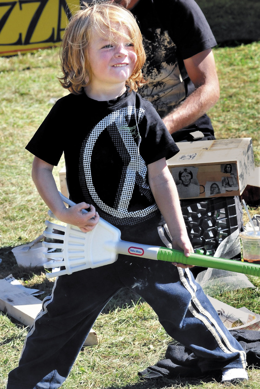 Aiden Henderson of Portland does some "air rake" as bands played during the Great North Fest music event in Norridgewock on Sunday.