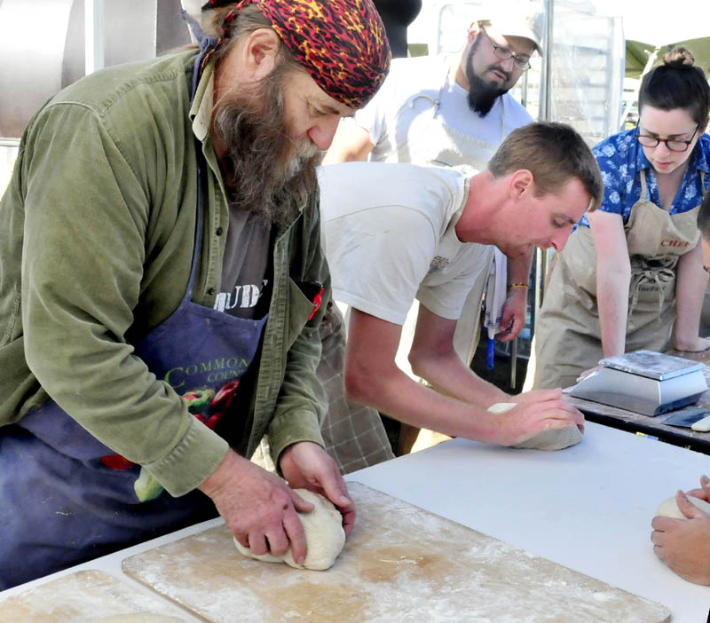 Dusty Dowse, left, and other bakers prepare dough Thursday for 500 loaves of rye bread to feed volunteers at the upcoming three-day Common Ground Country Fair in Unity. Others making bread from left are Jeff Dec, Lily Joslin and Dan Rivera, in background.