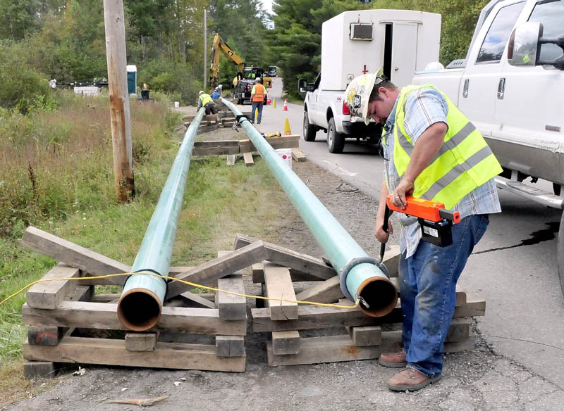 Jeremy Clubbs, of the sub-contractor U.S. Pipelines company, works on preparing to install gas pipeline sections outside Sappi in Skowhegan on Wednesday, Sept. 25, 2013. The spur will connect the mill to a main line running through Fairfield.