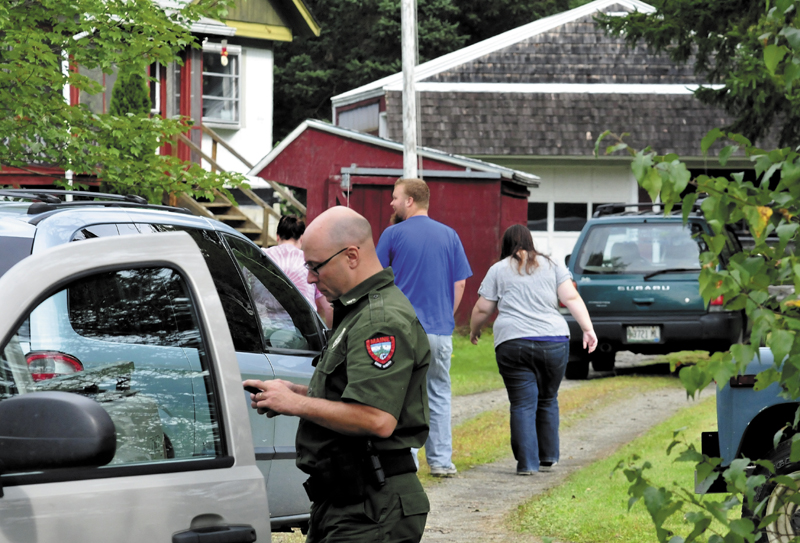 Game Warden Steven Couture prepares to search for Arthur Wakeman, 86, behind his residence in Benton on Thursday, Sept. 12, 2013 as family members arrive at the home. Wakeman was reported missing Wednesday evening.