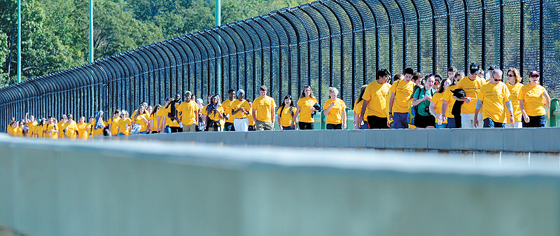 Volunteers walk Sunday across Memorial Bridge in Augusta during a fundraiser for Seeds of Peace, which trains youths from areas of conflict to be leaders.