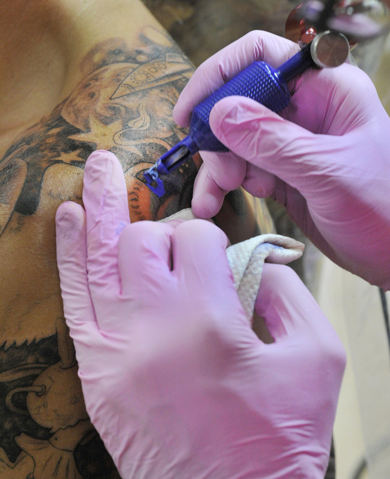 Chris Dingwell works on a tattoo for Jen Parker of Brattleboro, Vt., at his Chris Dingwell Studio.