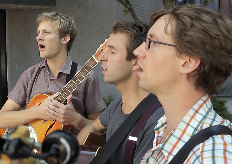 Kyle Morgan, from left, Peter Winne and Jake Hoffman sing a capella near Monument Square on Aug. 14.