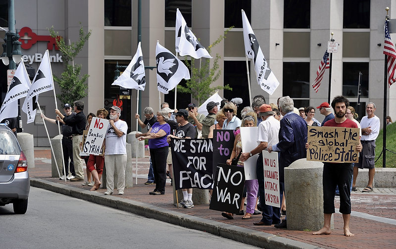 Veterans for Peace, Code Pink and Peace Action Maine hold a rally against U.S. intervention in Syria at Monument Square on Saturday. Michael Anthony of Portland, right, joined the rally with other objectives.