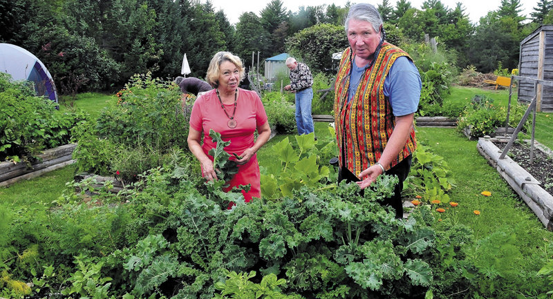 Connie Bellet and her husband, Phillip Frizzell, work in the Palermo Community Garden on Sunday. A lawyer representing the Legion now says there will be no bulldozers Monday.