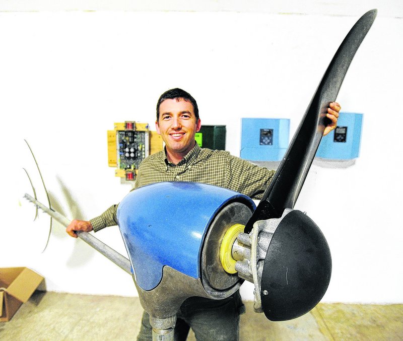 Ben Polito, president of Pika Energy in Westbrook, holds one of three blades on a personal-size wind turbine. 