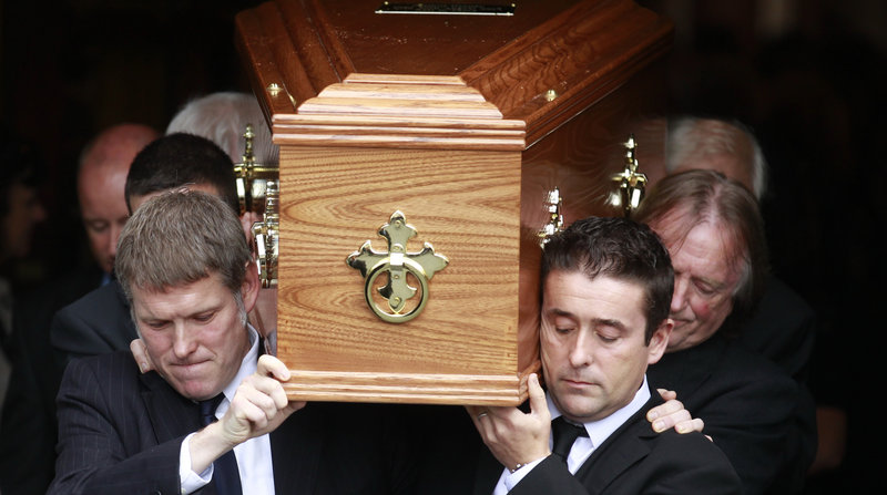 Family members carry the coffin of celebrated poet Seamus Heaney from Dublin's Church of the Sacred Heart on Monday.