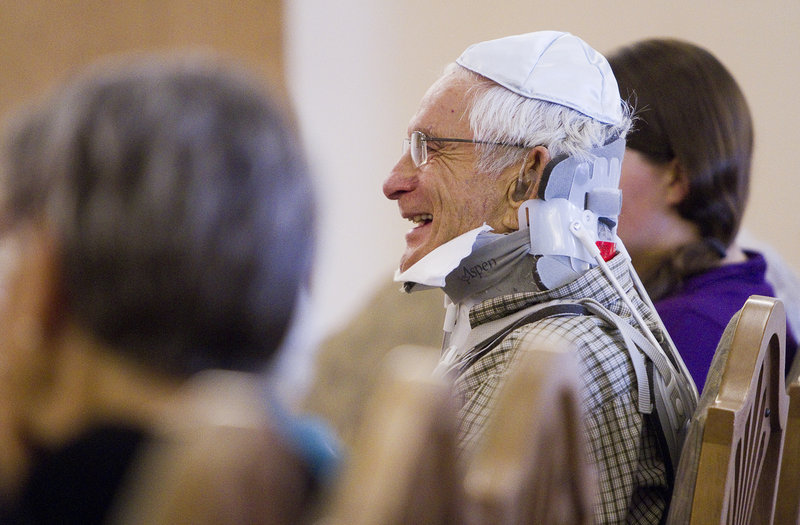 Carl Lerman, 86, resident of The Cedars retirement community in Portland, laughs during a Rosh Hashanah service, after stating his new year's wish to be "to get this brace off my neck". Rabbi Carolyn Braun performed a 30-minute ceremony at the retirement community Wednesday, Sept. 4, 2013.