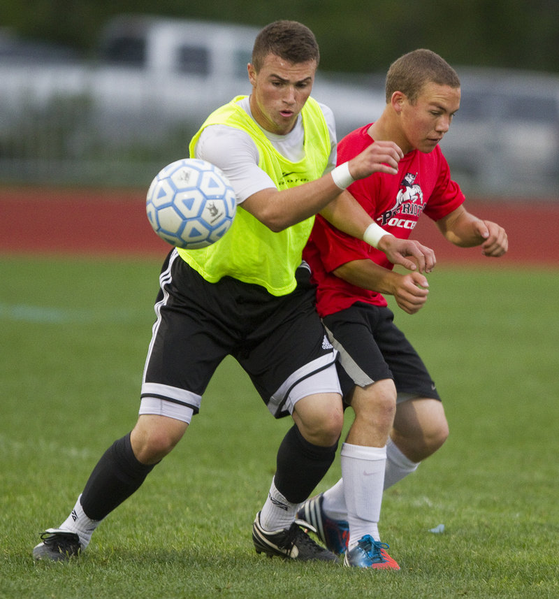 Spencer Hodge, left, battling with Gray-New Gloucester’s Jesse Lowell during a recent scrimmage, is one of the players who will be coached by Wally LeBlanc this season. LeBlanc coached the Falmouth girls last fall.
