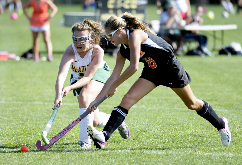 Katelyn Perkins of Biddeford, right, and Sophie Warren of McAuley compete for the field hockey ball Wednesday during Biddeford’s 16-0 victory in an SMAA opener at Portland.