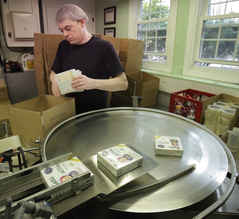 Tim Heffernan boxes some of the million-plus pounds of Kate’s Homemade Butter made annually in Old Orchard Beach. Neighbors say Kate’s is too big to be operating near homes.