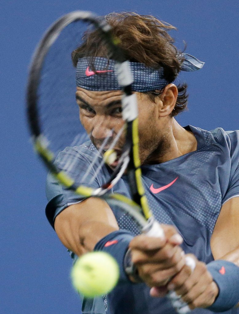 Rafael Nadal of Spain is all focus as he returns a shot against Tommy Robredo at the U.S. Open in New York on Wednesday. Nadal, advancing to the semifinals, won 6-0, 6-2, 6-2.