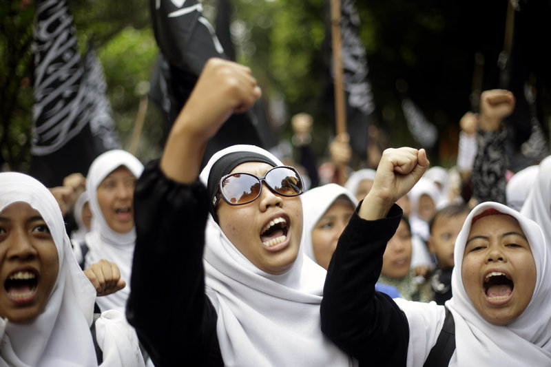 Muslim women in Jakarta, Indonesia, chant slogans during a protest demanding the cancellation of the Miss World pageant Thursday, saying it violates Islamic teachings.