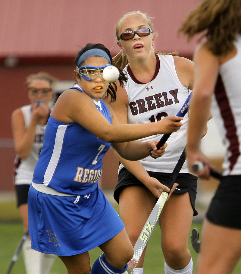 Bridgett Letarte of Lake Region, left, and Anna Murphy of Greely keep their eyes on the ball while contending for possession Thursday during Lake Region’s 5-0 victory in field hockey.
