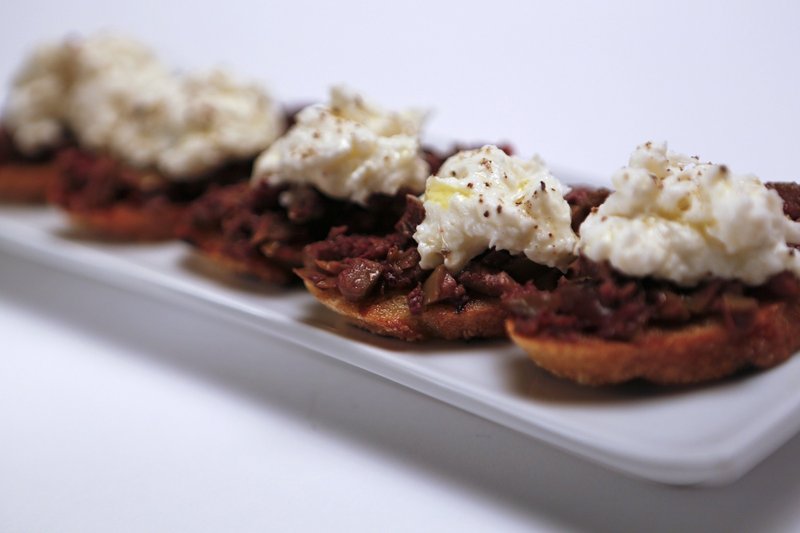Bruschetta topped with burrata and tapenade