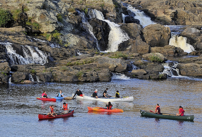 First arrivals to the Great Falls enjoy socializing in their kayaks and canoes as they await later arrivals during the Androscoggin Land Trust’s “Paddle After Hours” last week, an event organized by Jonathan LaBonte, Auburn’s mayor and the land trust’s executive director.
