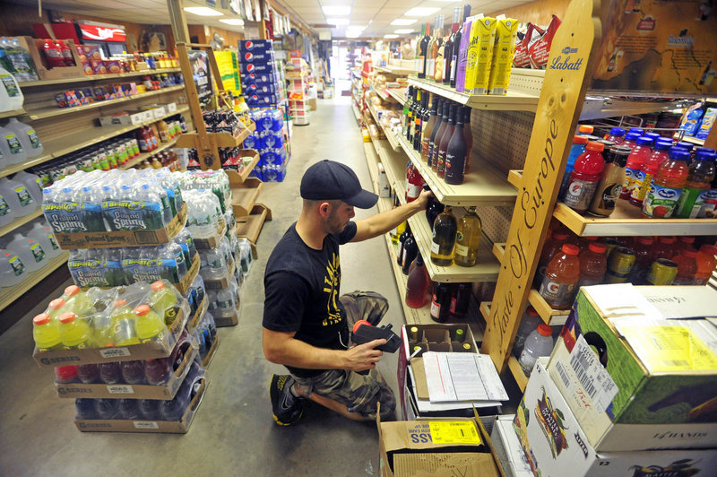 Brandon Berry stocks shelves during his afternoon shift at the family’s general store.