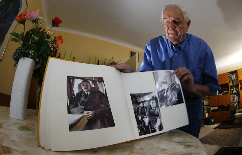 Rochus Misch, who worked as a courier, bodyguard and telephone operator for Adolf Hitler, shows his picture book during a Reuters interview in Berlin in 2007. Misch, who died Thursday at the age of 96, was with Hitler until the end.