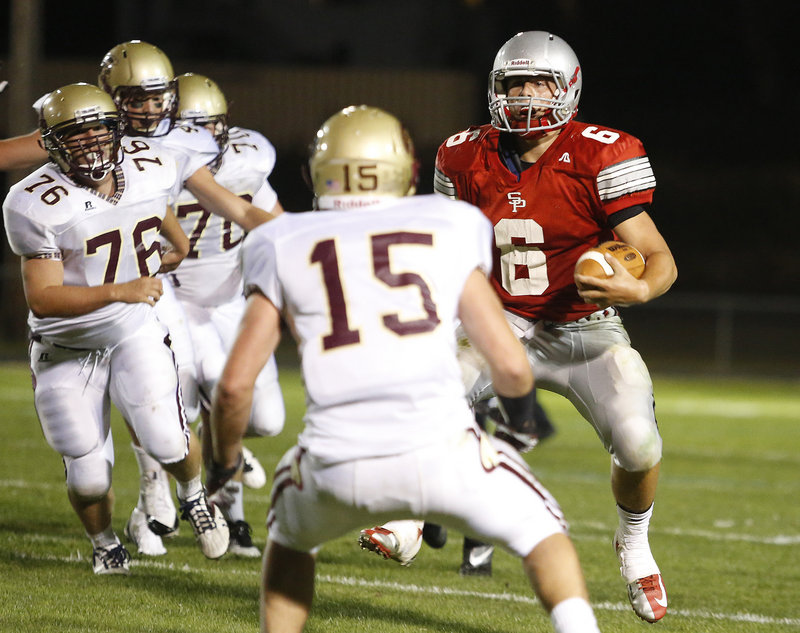 Duncan Preston, who ran for 137 yards and threw four touchdown passes Friday night for South Portland, weaves his way through the Thornton Academy defense for a first down in the second half. South Portland defeated the defending Class A champion, 26-13.