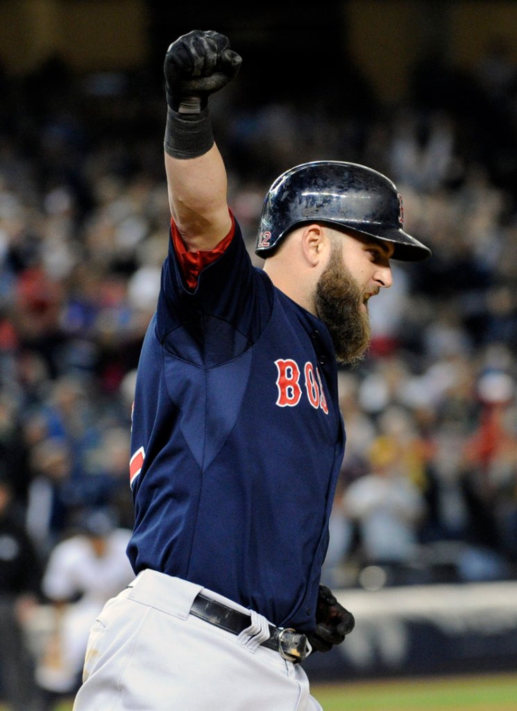 Mike Napoli celebrates a tying grand slam in the seventh inning. The Sox went on to beat the Yankees, 12-8.